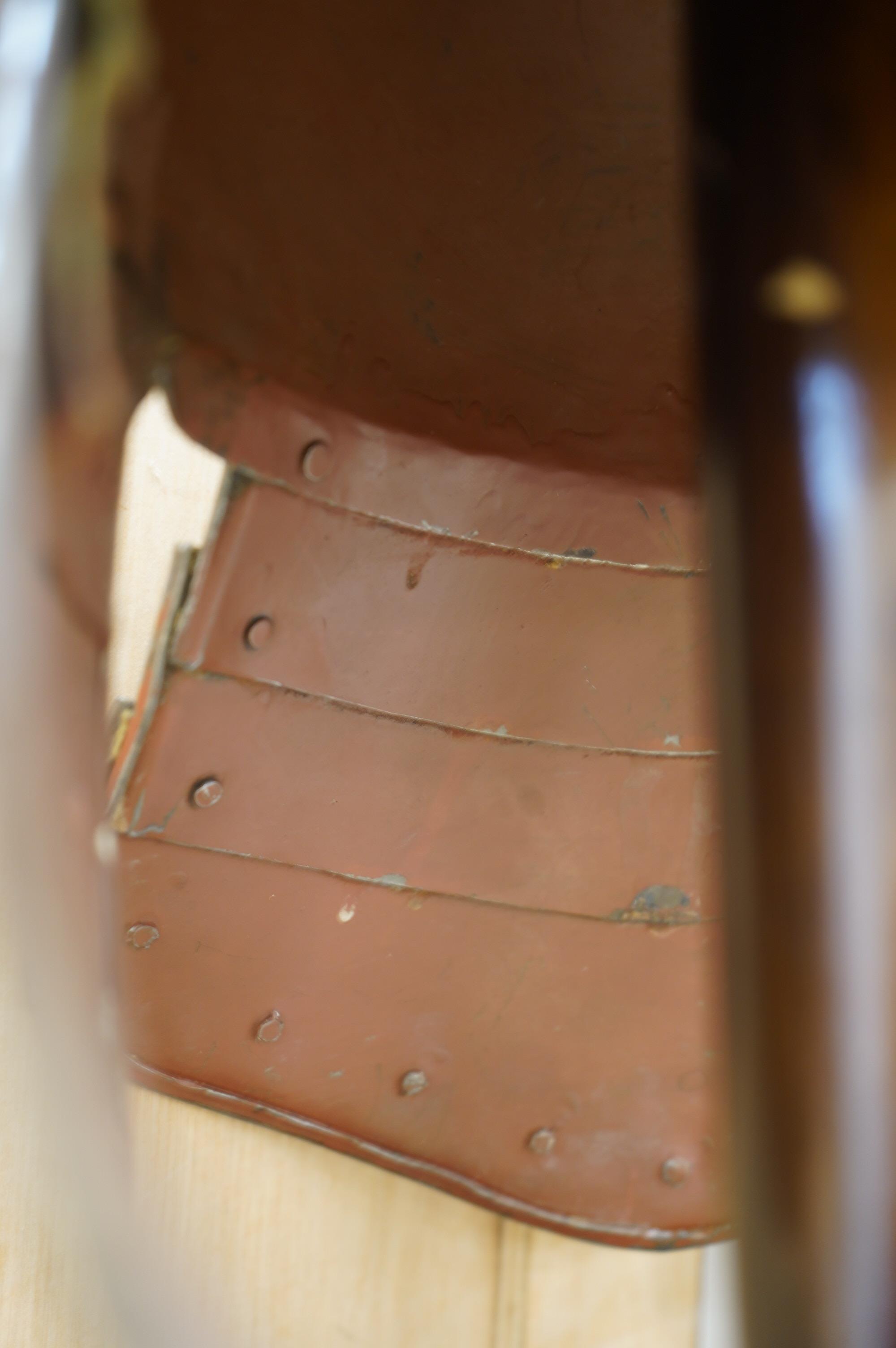 A replica suit of English Civil War armour on a stand, comprising; a lobster pot helmet, breastplate and back plate. Condition - poor to fair